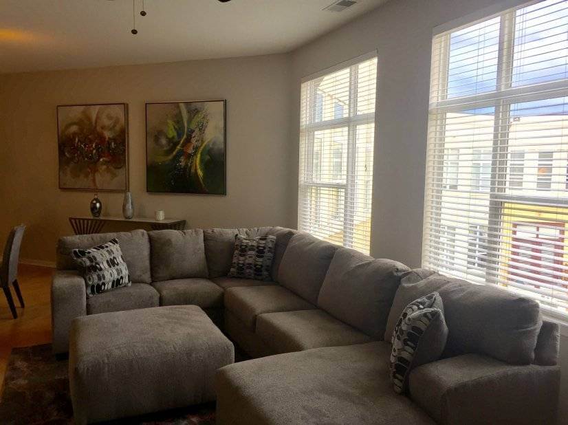 Light filled living room with sectional and 5