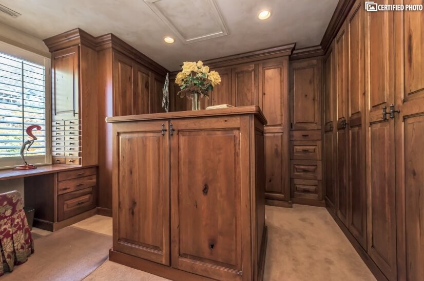 custom closet with private vanity and natural lighting