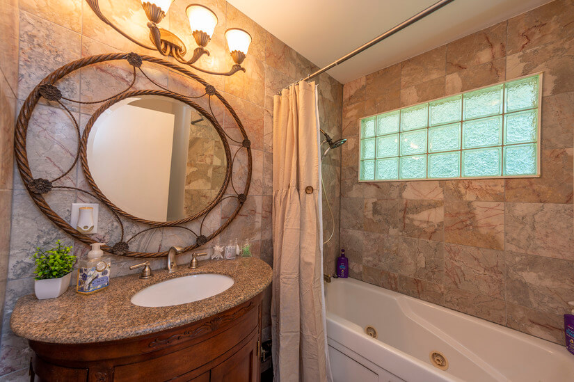 Stunning bathroom has shower and jetted tub combo.