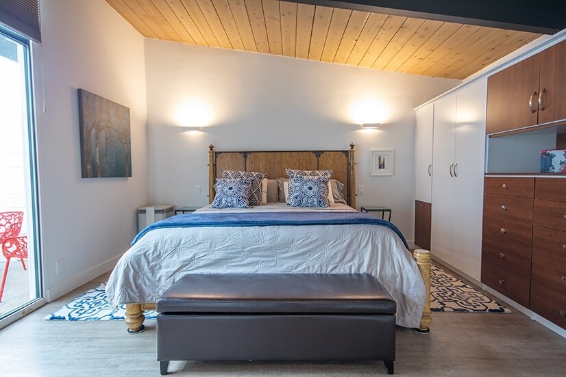Master bedroom with large closet and courtyard view