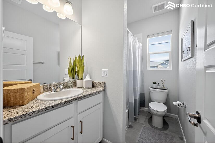 Upstairs guest bath with vanity, tub, and shower