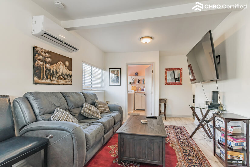 Recliner Couch, big TV, and Real Persian Rug.