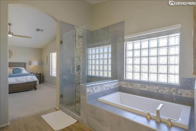 Custom stone & tile shower & deep soaking tub in master