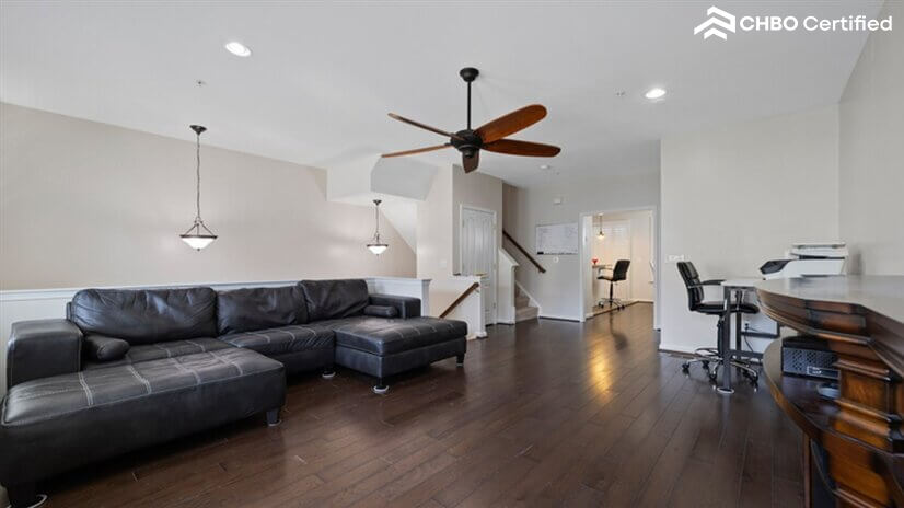 Large sofa with ottoman in spacious common area.