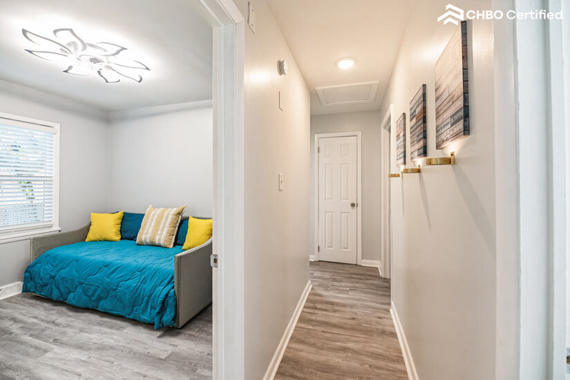 Long hallway w/ 
inspirational wall art and lighting