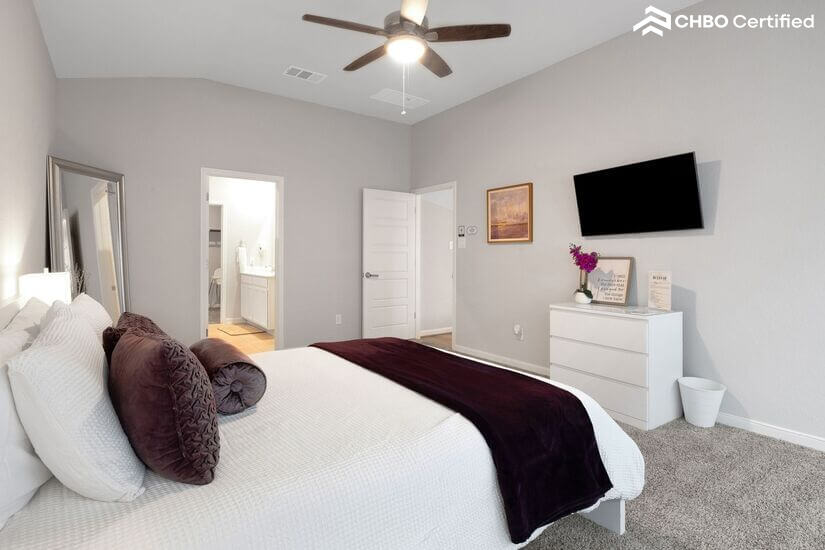 Master bedroom with Smart TV and private bath access.