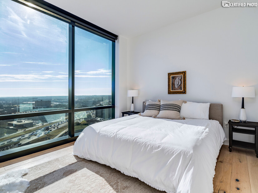 Primary king bedroom with full views & shades for privacy