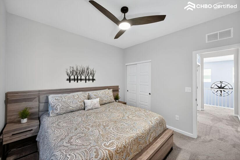 Upstairs guest room with ceiling fan
