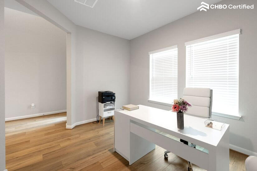 Home office with desk, ergonomic chair & laser printer.