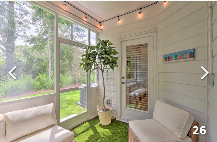 Screened-in patio with wooded view.