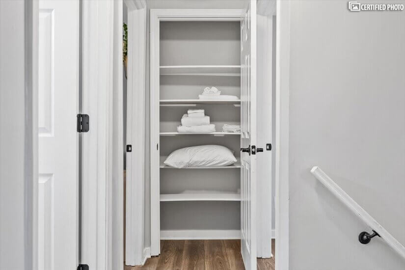 Hall closet with extra towels and pillow