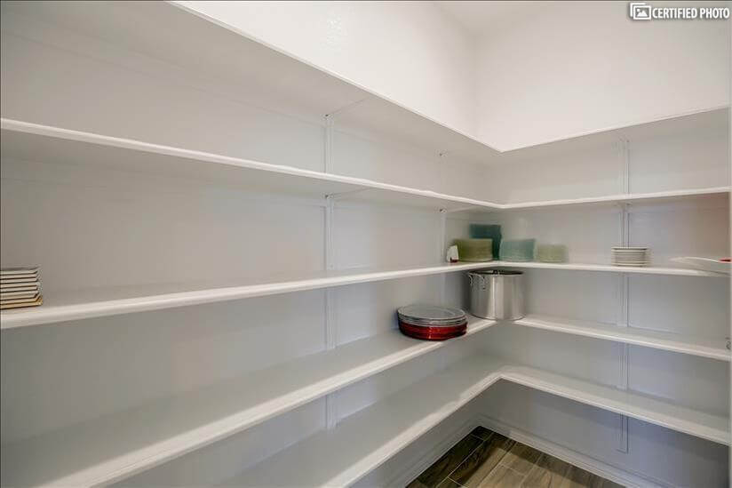 Extra large walk-in pantry with plenty of shelves.