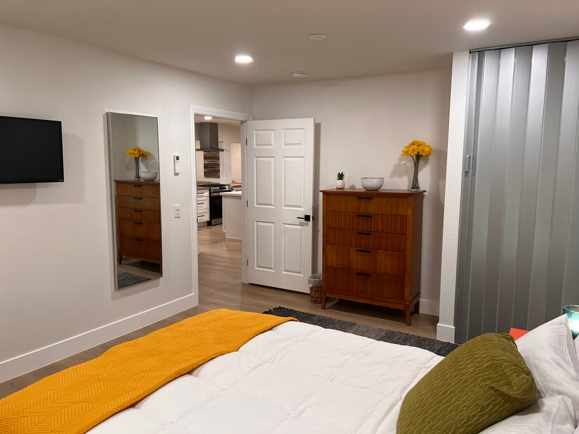 guest room with closet and mounted TV