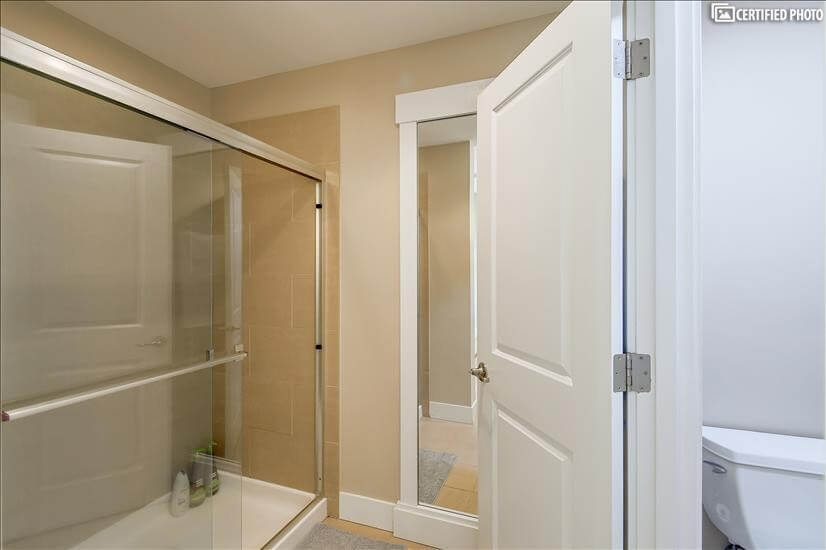 Primary bedroom’s shower and comfort-height toilet