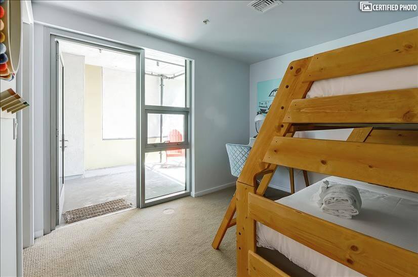 Smaller bedroom has large private patio.