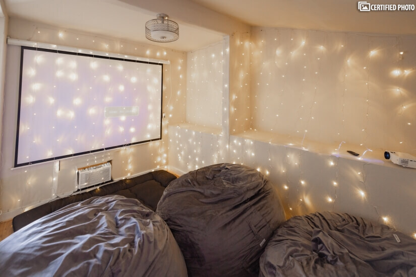 Movie room with projector and comfortable poufs