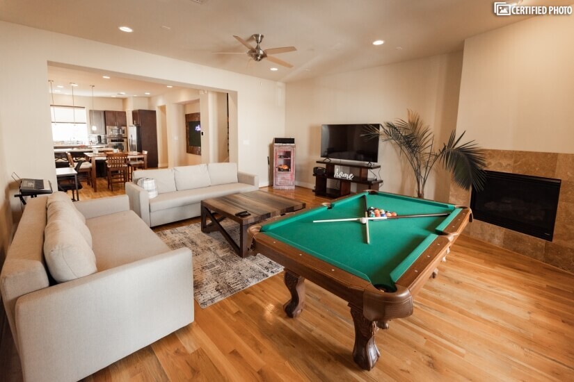 Livingroom and game room of this furnished rental in Houston