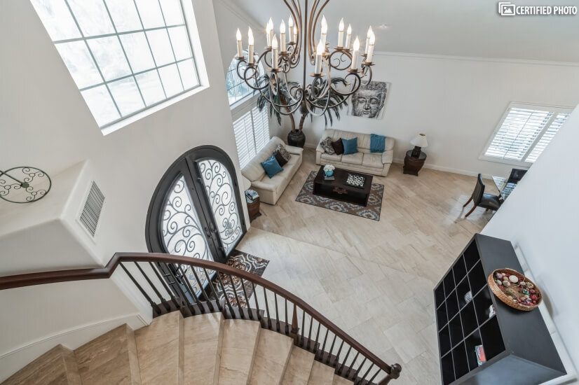 Gorgeous spiral staircase and travertine flooring throughout