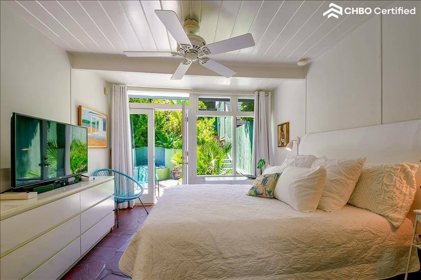 Master bedroom with double door view of the garden.