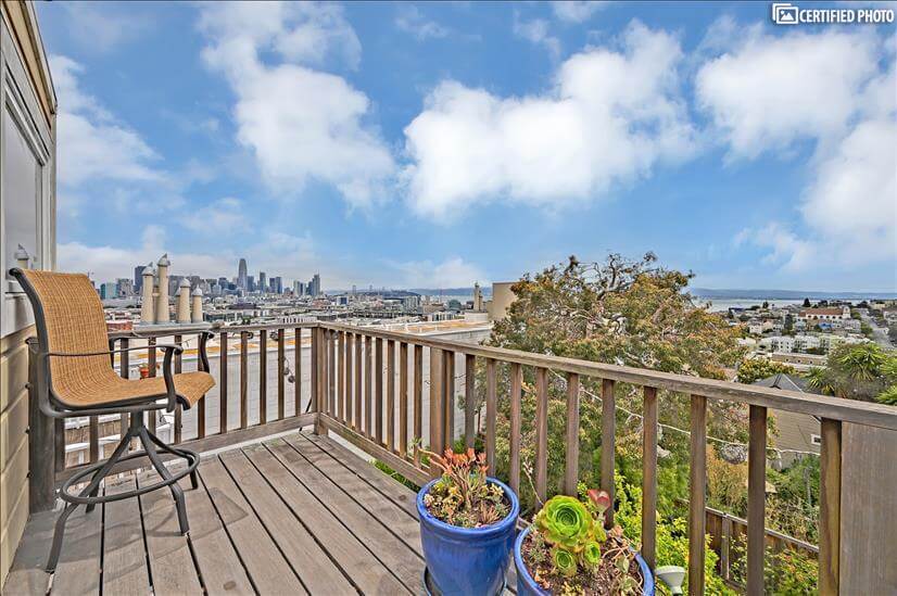 top floor deck with view of city skyline and bay