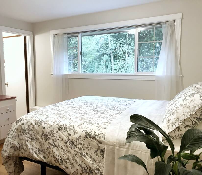 Bedroom with attached bathroom and queen bed