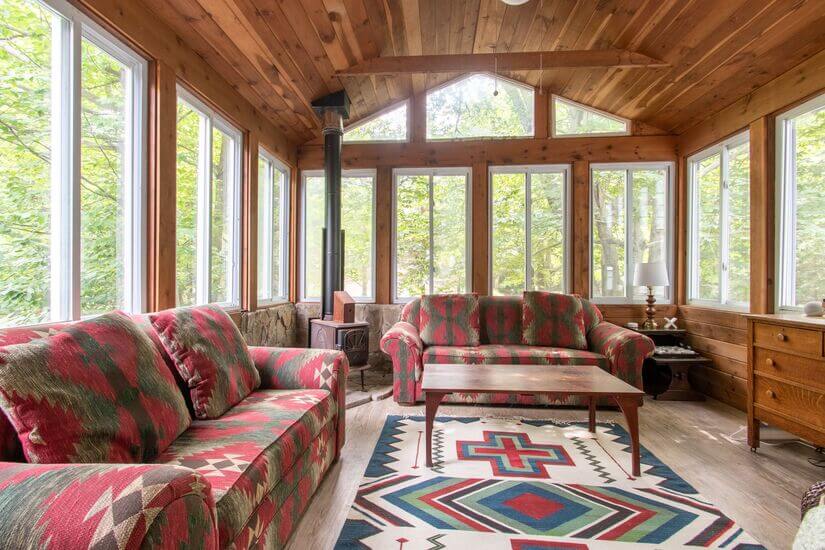 The sunroom has a working wood stove