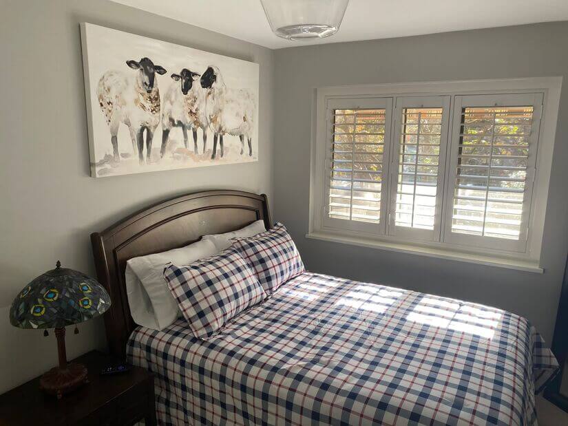 Bedroom 2 w large window and artwork