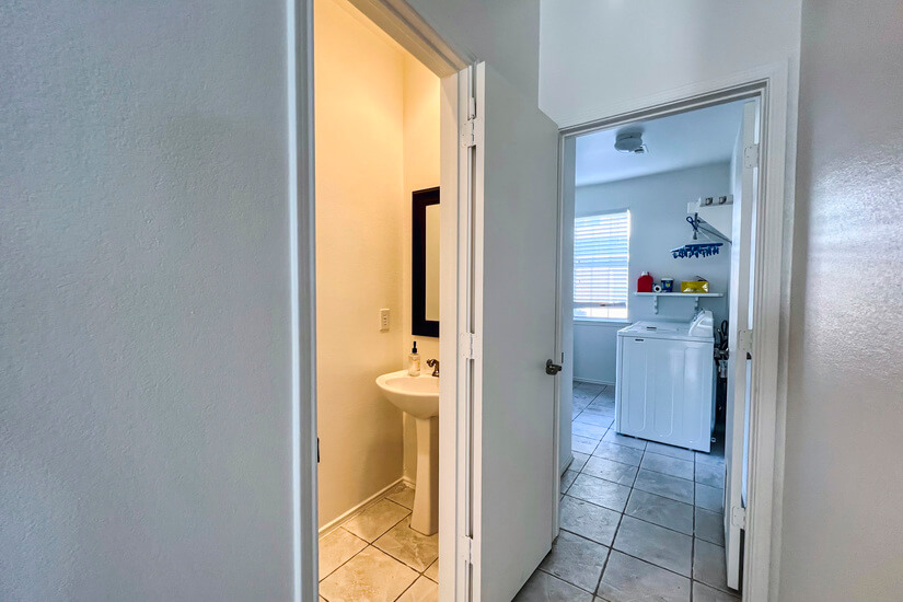 Guest half bath with view of washer/dryer