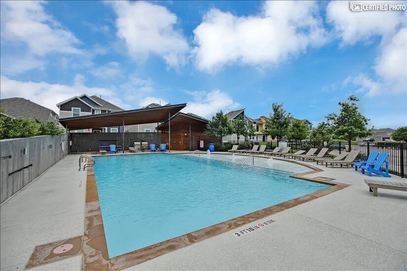 Large private community pool with two BBQ grills.