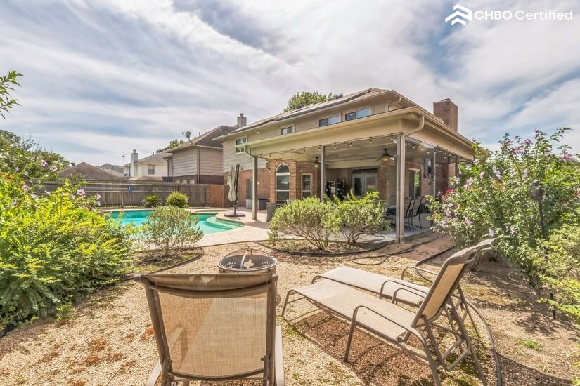 Back yard with pool and hot tub.