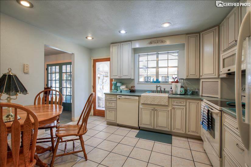 Kitchen connects to sun and dining rooms.