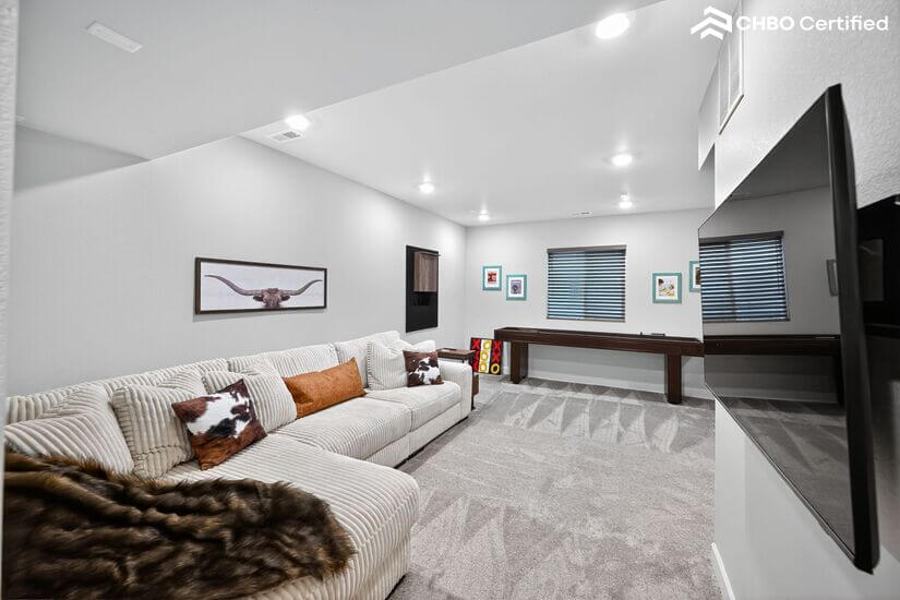 Finished and Furnished basement with large couch and TV