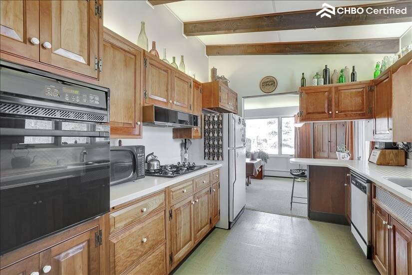 Gallery style kitchen with antique bottles