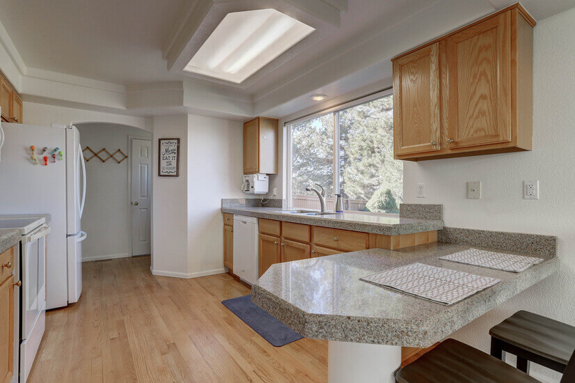 Kitchen into laundry area, 1/2 bath, pantry, and garage