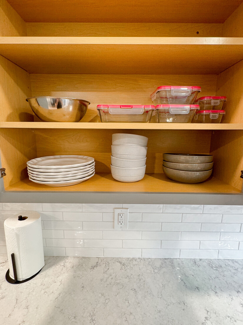 Stocked with plates, bowls, silverware and food storage