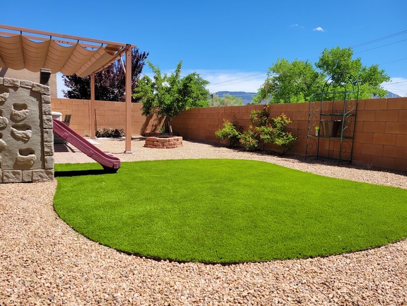 Backyard with artificial grass and view of Sandia mountains.