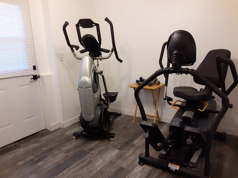 Exercise Room with Cardio, Weights, TV. Patio access