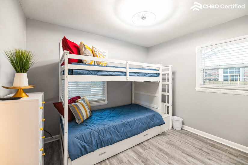Bedroom #2 w/ twin bunk beds and fancy light fixture