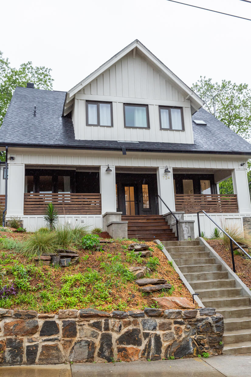 Charming front exterior with lush landscaping