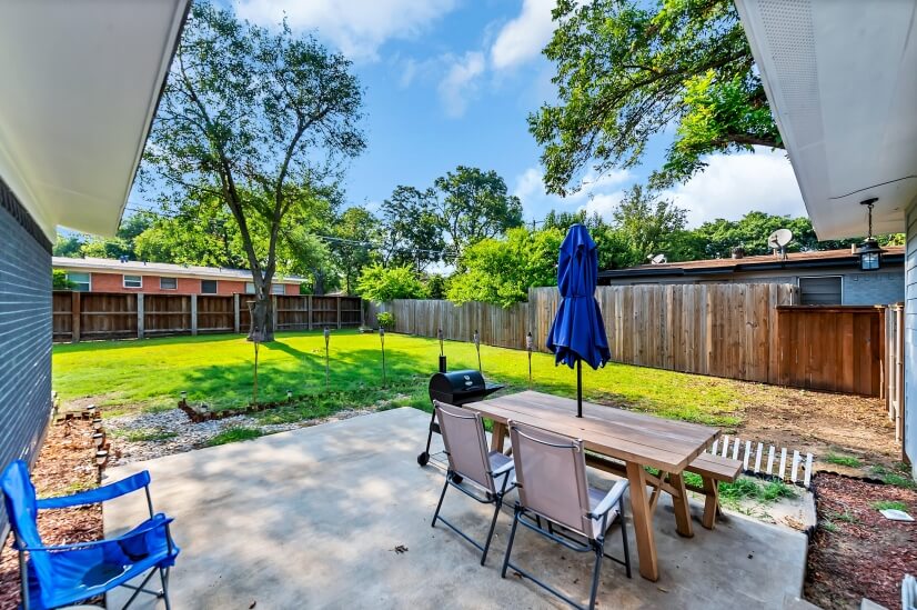spacious fenced in backyard with grill and dining area!