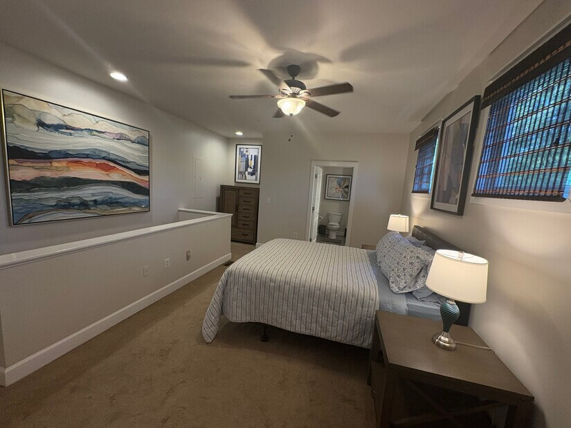 Carpeted bedroom with ceiling fan