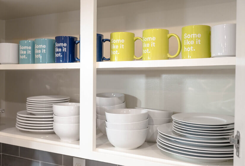 Kitchen fully stocked with dinnerware/mugs