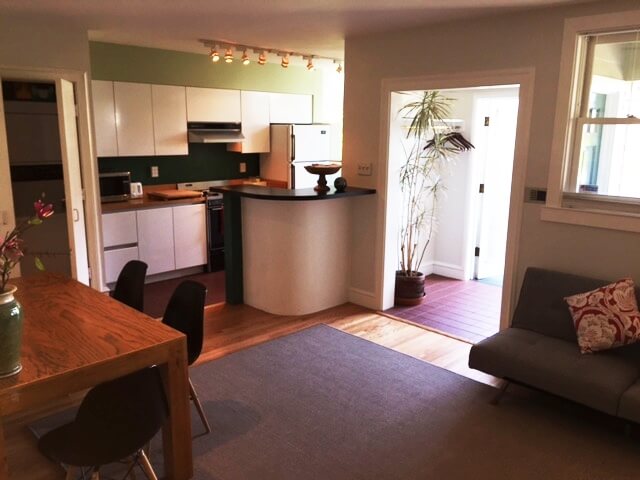 Partial view of living room and open kitchen