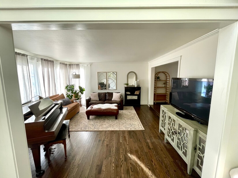 Living area w/ beautiful natural lighting & baby grand piano
