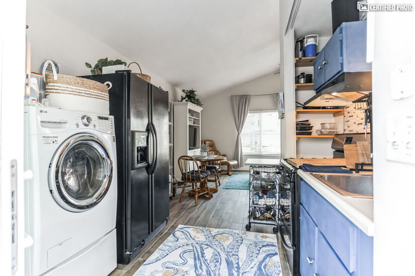 Full-size refrigerator and all-in one washer dryer in studio