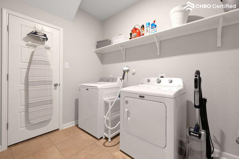 Full laundry room with washer and dryer inside.