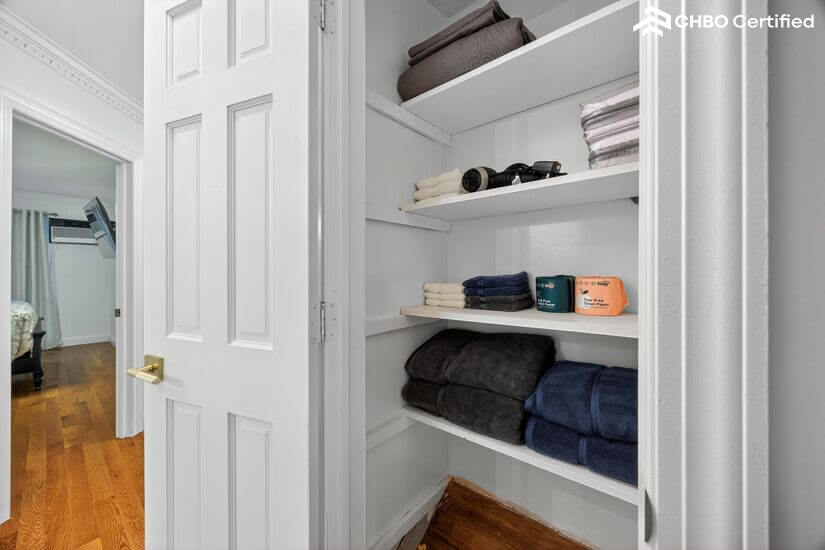 Closet with bath towels, wash cloths and bed sheets