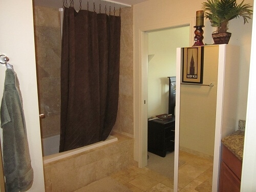 Bathroom with travertine tile and jetted tub.