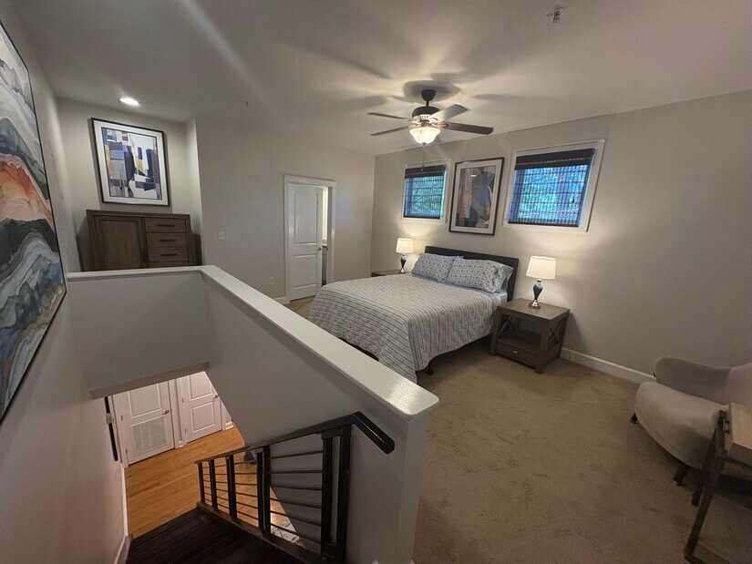 View of bedroom from top of stairs