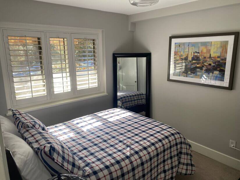 Well lit bedroom with Full size bed